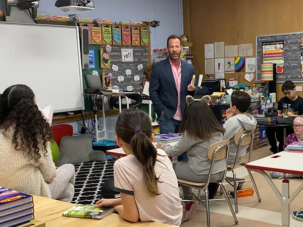 Rob Levine speaking with a classroom full of kids about reading