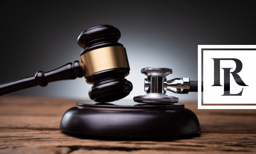 Gavel and stethoscope on desk