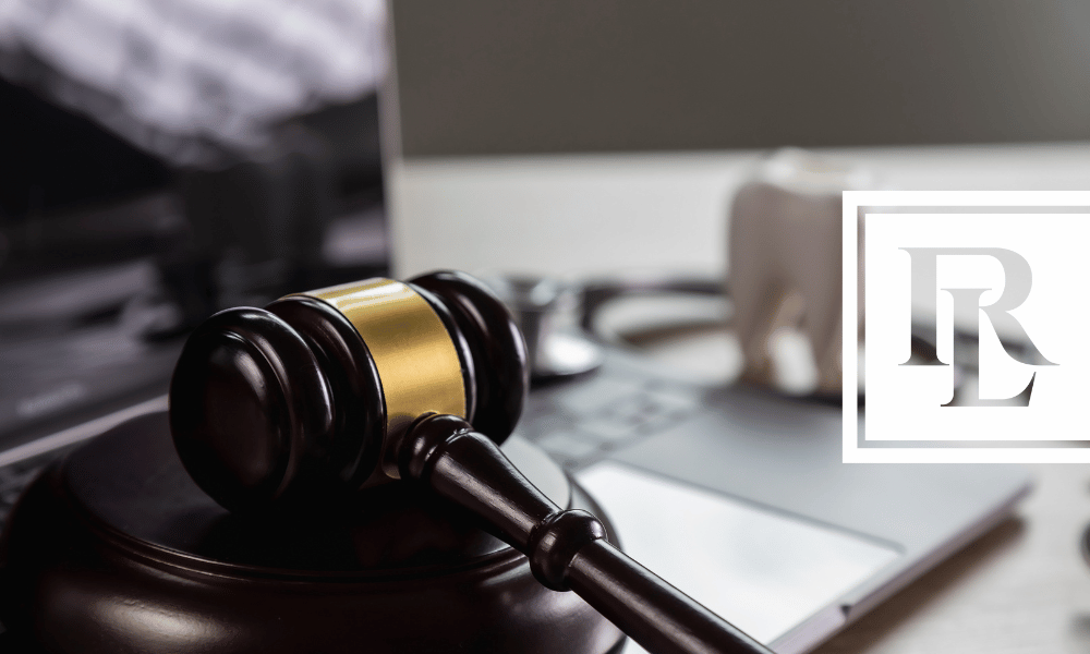 Gavel on desk next to medical equipment