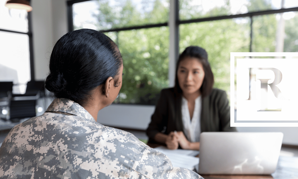 Soldier speaking with woman across a desk