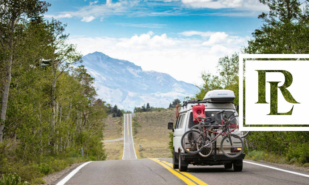 Car going on a road trip on a road with a mountain in the background