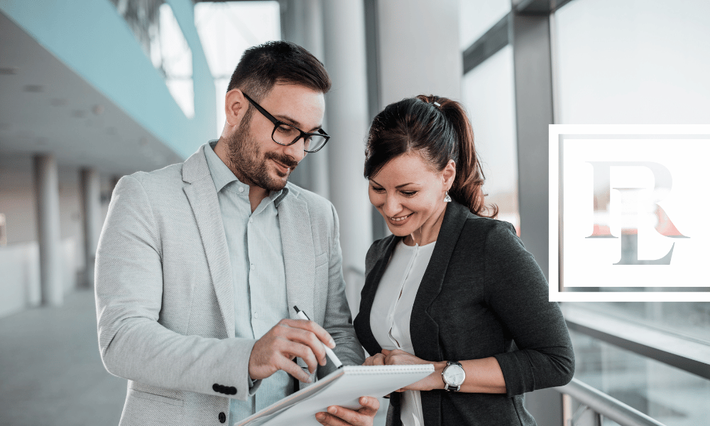 Two people looking at a paper