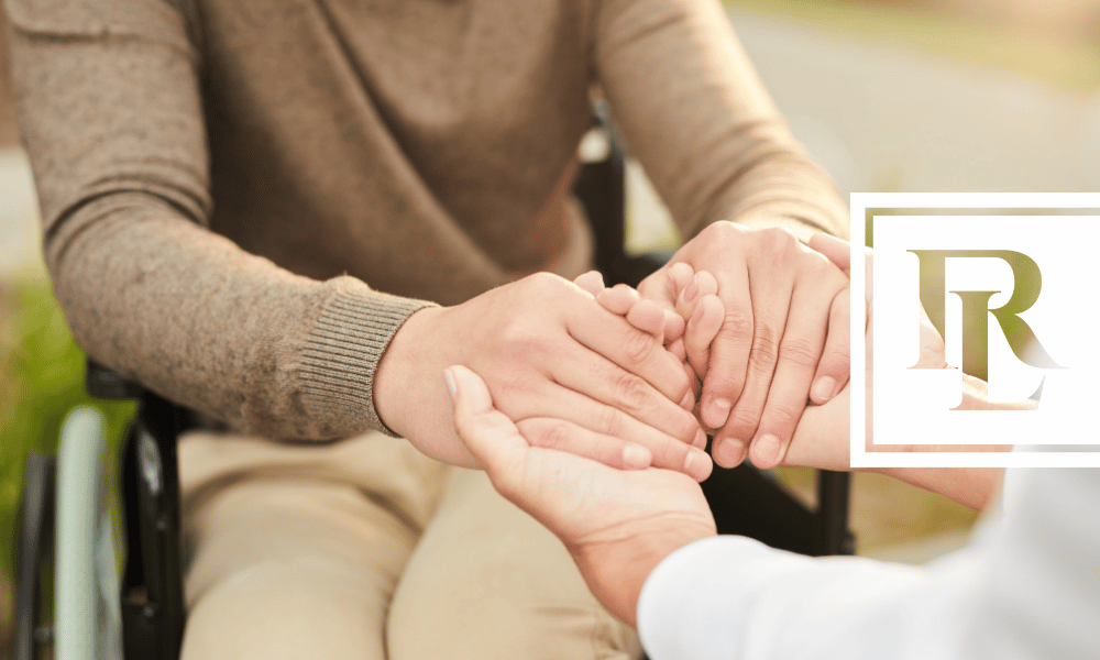 Person in wheelchair placing hands in another person's hands