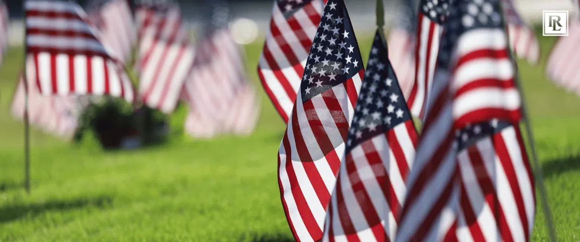 Close-up of American Flags on green lawn