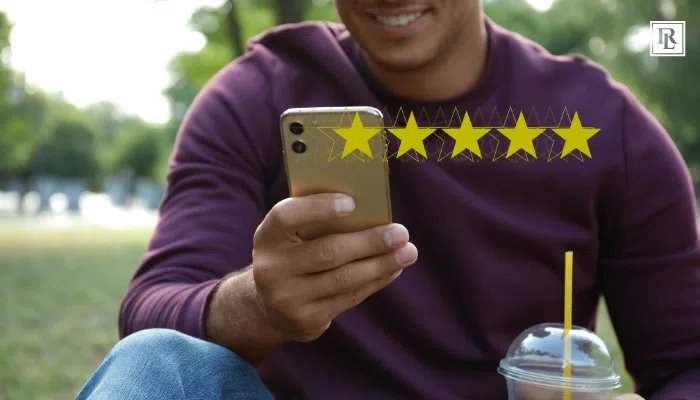 happy man leaving a 5 star review on his phone