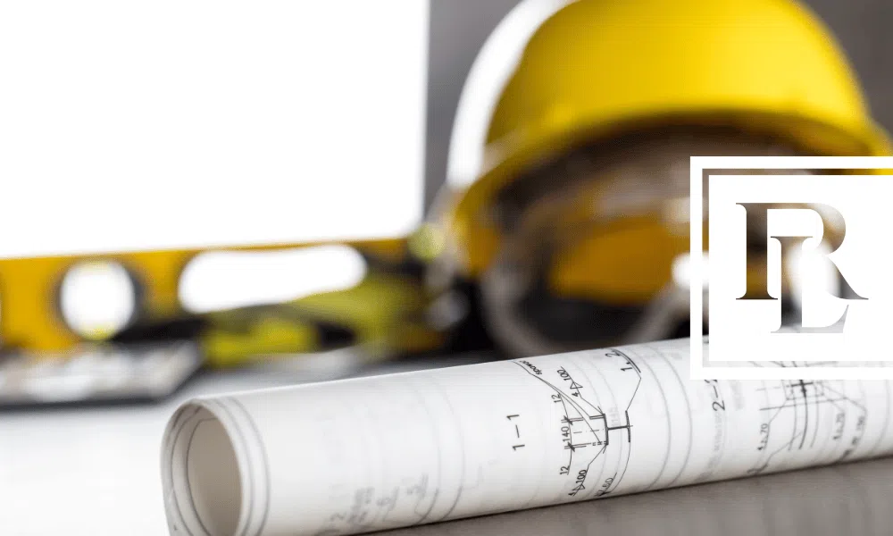 hard hat sitting next to blueprints