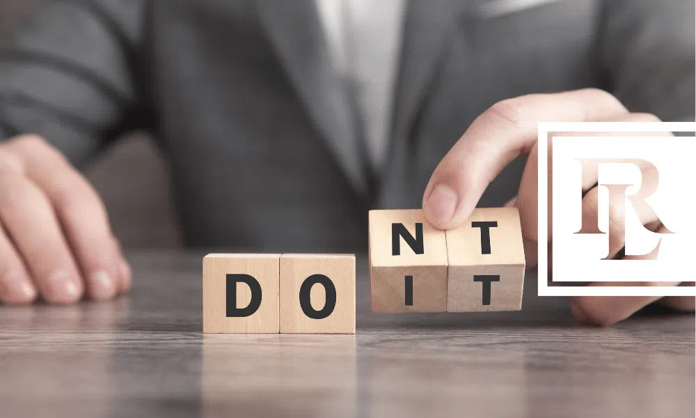 A lawyer holding letter blocks spelling out "don't do it"