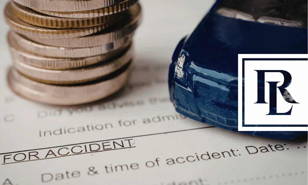 A toy cay and a stack of coins on a car accident form.