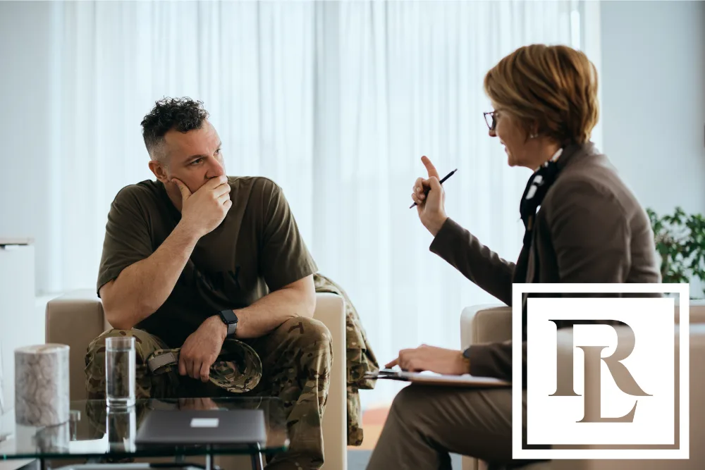 A man wearing a military uniform talking to a legal professional